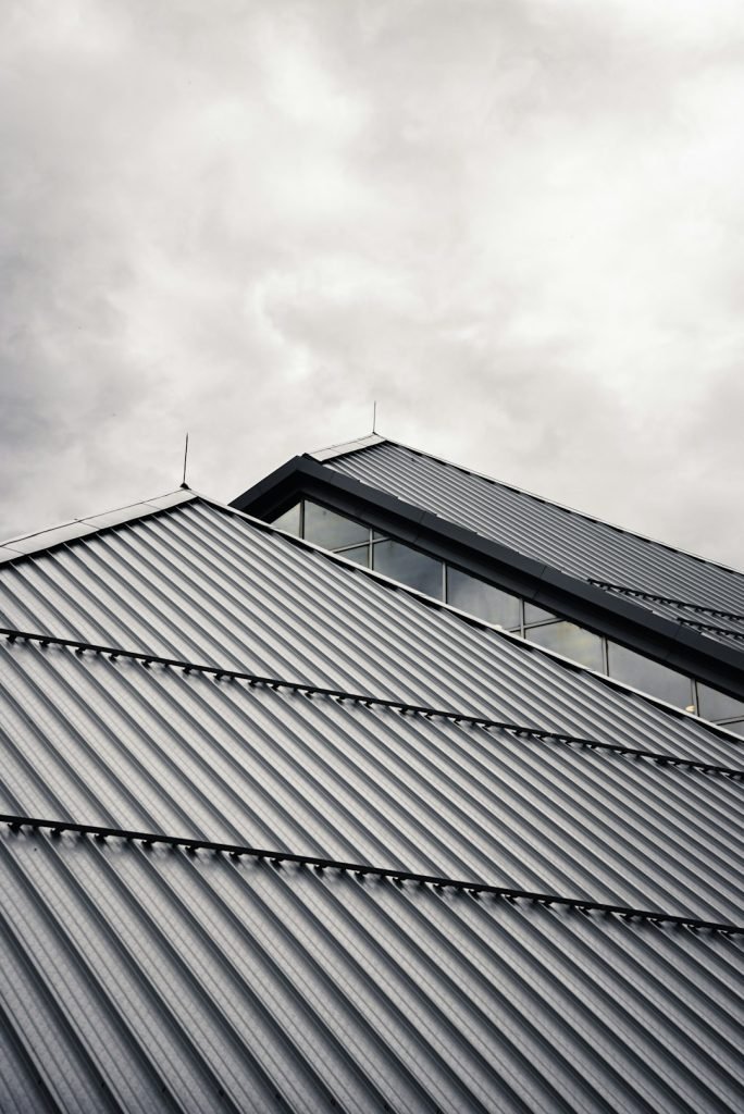 gray-and-black-building-under-white-clouds-jbzpse1sd7o